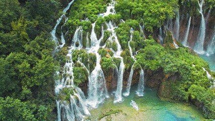 Tropical forest and mountain landscape with streams of water and waterfalls. Cascades flow among...