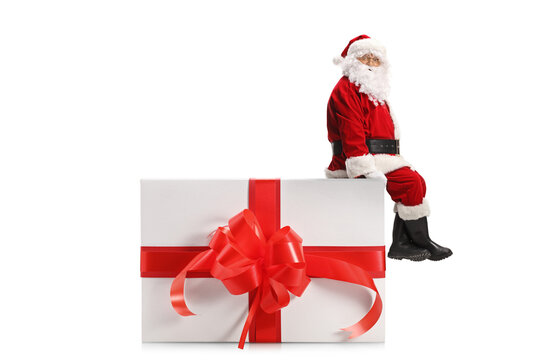 Santa Claus sitting on a big christmas present box