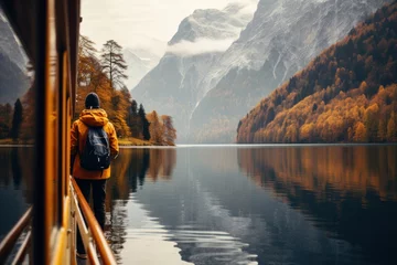 Fotobehang man photographing konigsee lake in alps in fall © Tisha