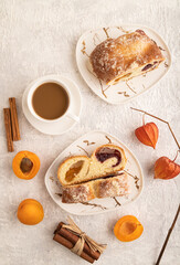 Homemade sweet bun with apricot jam on gray concrete. top view.