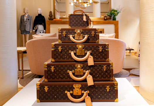  ITALY, MILAN, 25, AUGUST, 2023: Louis Vuitton's  trendy suitcases and bags stand in the center of the boutique's sales area at Milan, Italy