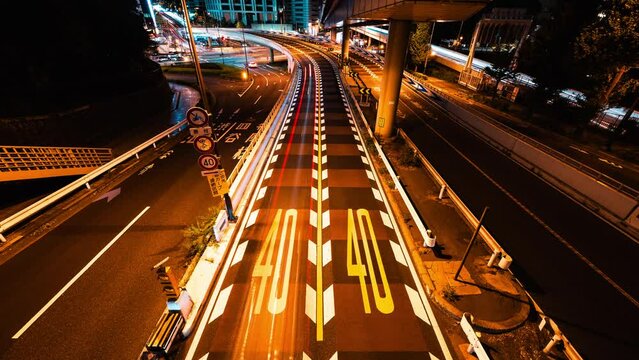 Long Exposure Timelapse of fast moving car traffic transportation on road, highway, bridge in Tokyo Japan. Speed limit sign on ground. Japanese transport culture, Asia commuter, Asian city night life