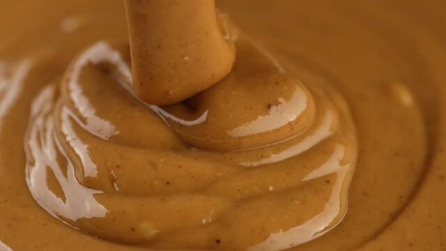 Peanut butter. Pouring peanut butter, close up