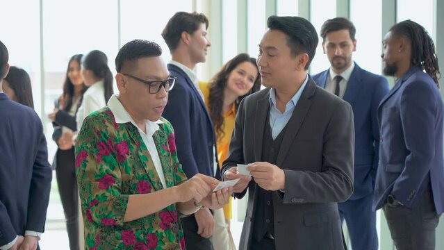 group of diversity business people shaking hands and greeting each other Exchanging Business Cards after a meeting conference or seminar. Communication in Corporate at office. connecting people. asian