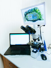 Modern digital microscope equipped with camera, computer in laboratory