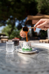 Traditional Turkish coffee, cezve and cup.