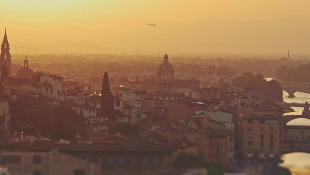 Cathedral of Saint Mary of the Flower at sunrise or sunset, Italy, Florence. Plane flying over picturesque golden sunset city landscape. Tourism, holidays, weekend, vacation concept. Famous attraction