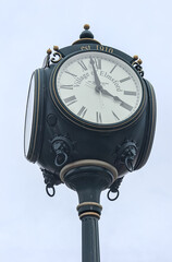 Fototapeta na wymiar street clock detail in elmsford, new york (westchester, downtown village near tarrytown) greeburgh (ornate clock with roman numerals for hours and fancy hands) close up