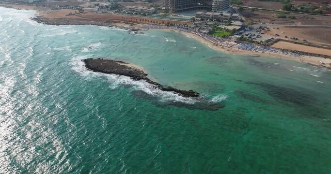 Aerial view of the beach in Ayia Napi, Cyprus. Resorts and rocky beaches on the coast of the Mediterranean Sea. High quality 4k footage