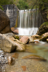 Lonely waterfall, long exposure in the green forest.