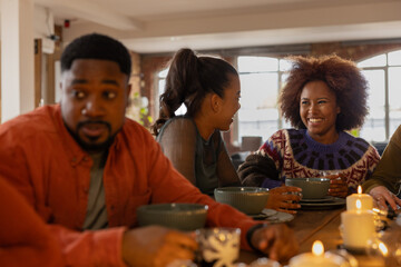 Friends gathering in a loft apartment for a celebration meal together