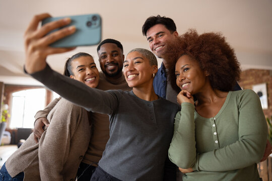 Group of friends taking a selfie in a loft apartment