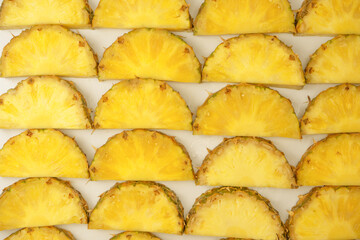 Pineapple juicy yellow slices on a white background.