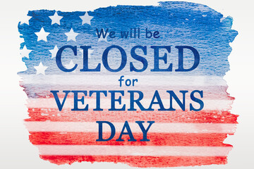 Signboard with the inscription We will be closed for Veterans Day. Card painted in watercolors. Inscription on the background of the American Flag. Closeup, view from above