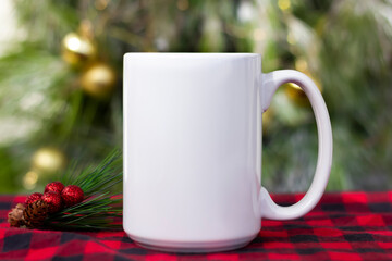 White 15 oz white mug on a red green christmas background . 15 oz , big, large cup mock up for your...