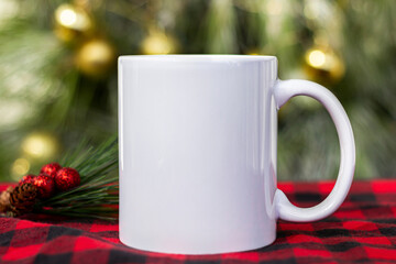  White 11 oz white mug on a green christmas background . 11 oz cup mock up for your cup design