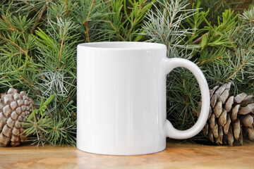  White 11 oz white mug on a green christmas background . 11 oz cup mock up for your cup design