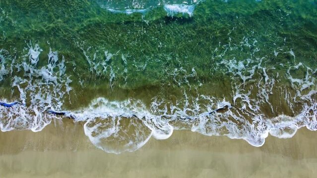 Summer seascape, beautiful waves, blue sea water on sunny day. Top view from drone. View of sea from height of tropical nature. Beautiful bright sea with lapping waves and beach sand concept