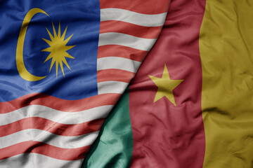 big waving realistic national colorful flag of malaysia and national flag of cameroon .