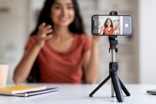 Phone on tripod recording millennial indian lady influencer