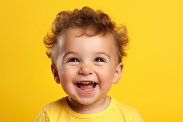 One funny boy laughs and smile, studio yellow background. Handsome curly hair kid look at camera. 3 years old cute child generated by AI - obrazy, fototapety, plakaty