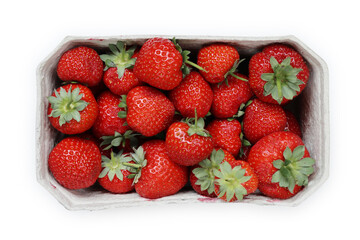 Freshly harvested ripe garden strawberries in recycled paper food container on a white background, top view close-up. Copy space.