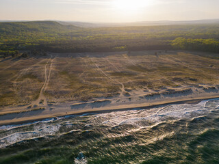 Aerial view of the sea, beach, and forest from above. It's a beautiful natural landscape that's perfect for nature lovers and anyone seeking a scenic and picturesque escape.