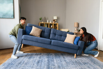 Young Asian Couple Lifting Heavy Sofa Furnishing Modern Living Room