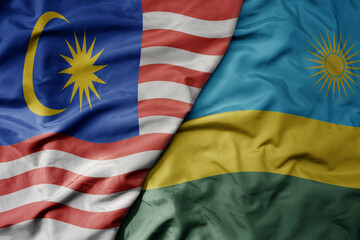 Obraz premium big waving realistic national colorful flag of malaysia and national flag of rwanda .