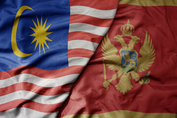 big waving realistic national colorful flag of malaysia and national flag of montenegro .