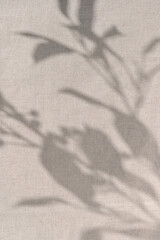 Aesthetic floral sunlight shadows pattern on neutral beige linen cloth texture background....