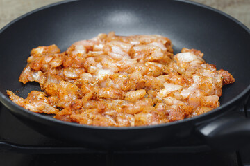 Making turkish doner kebab at home. Raw chicken pieces on frying pan. Marinated chicken in spices....