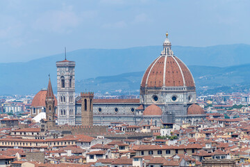Fototapeta na wymiar Cathedral of Santa Maria del Fiore in Piazza del Duomo, Florence, Italy seen in middle of city surrounded by typical houses with red roofs