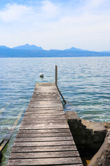 Fototapeta premium Wooden pier overlooking the Alps and Lake Geneva in Switzerland