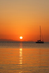 Naklejka na ściany i meble Boat at Sunset on the Sea