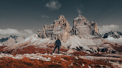Amidst the breathtaking majesty of the Dolomite Mountains, a rugged and intrepid man stands in awe...