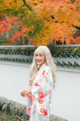 Asian woman wearing kimono in autumn. Japan autumn.