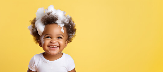 banner copyspace Little smiling african American baby boy with big soap foam on head in hair. on solid yellow background, Shampoo, hair treatment and soap for children, childs bathing time.