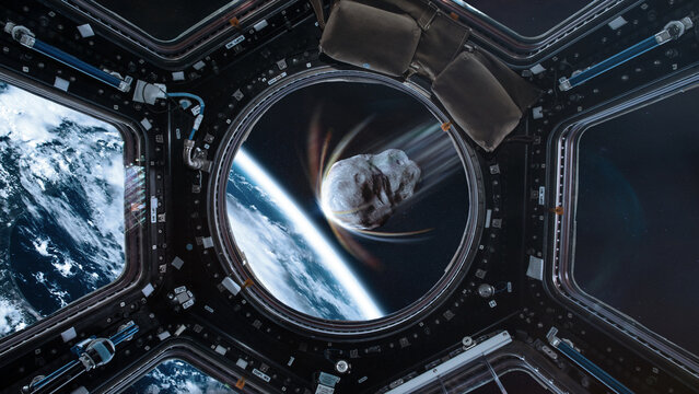 Planet Earth and big asteroid in spaceship porthole in outer space. Meteorite in outer space near Earth planet. Elements of this image furnished by NASA.