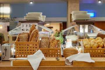 Breakfast in a business hotel, view of the morning food menu. Baskets with pastries of various...