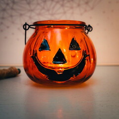 Decoration for Halloween. Close up view of an orange pumpkin shaped glass.