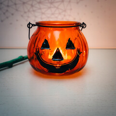 Decoration for Halloween. View of an orange pumpkin shaped glass.
