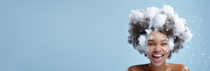  banner portrait beautiful african American model girl with big soap foam on head in hair on solid blue background, hygiene, Shampoo, hair treatment and soap, bathing time , copyspace . - obrazy, fototapety, plakaty