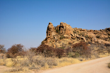 A rocky ridge in the desert against a blue sky. Hot climate and dehydration