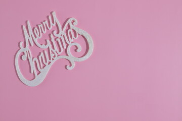 Merry Christmas text, celebrationg card, pink background