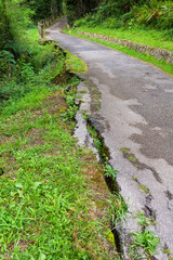 Obraz premium Destroyed roadside of country road after the landslide