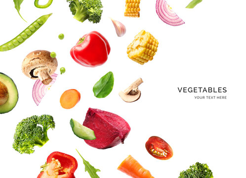 Creative layout made of flying vegetables on the white background. Flat lay. Food concept. Macro  concept of avocado, broccoli, corn, peppers, carrot, garlic, onion, beetroot, tomato, cucumber.