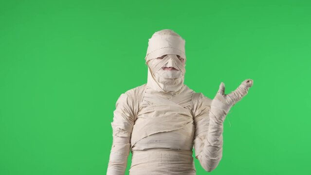Green screen isolated chroma key video capturing a mummy smelling under its smelly arms, swinging hand in front of its nose because it's stinky.