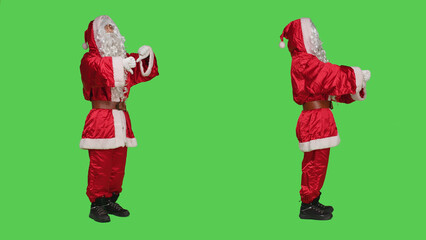 Father christmas gives thumbs down in studio, expressing frustration and disapproval when he should be spreading joyful holiday spirit. Santa claus showing dislike sign, displeased man.
