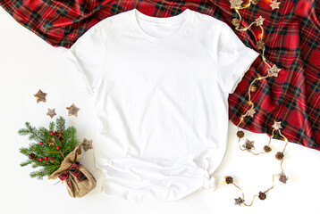 Flat lay mockup of white tshirt with Christmas accessories. X mas 3001  t shirt top view and white background - obrazy, fototapety, plakaty